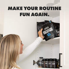 Person reaching for a supplement package on a shelf with text 'MAKE YOUR ROUTINE FUN AGAIN.' | blue raspberry 